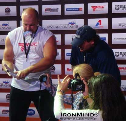 Talk about being on the spot: with referee Alexey Tyukalov keeping a close eye on the attempt, Aleksandr Asinowski squared off with the Captains of Crush No. 3 gripper while two cameras captured the action at close range.  IronMind&reg; | Courtesy of Alexey Tyukalov.