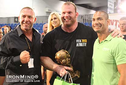 Derek Poundstone (center) is headed to World’s Strongest Man 2013, after winning Giants Live–Melbourne . . . and he did with one arm. That’s Paulo Freitag (Alkaline Nutrition) on the right and Tony Doherty (FitX promoter) on the left. Photo courtesy of Giants Live. Derek Poundstone (center) is headed to World’s Strongest Man 2013, after winning Giants Live–Melbourne . . . and he did with one arm. That’s Paulo Freitag (Alkaline Nutrition) on the right and Tony Doherty (FitX promoter) on the left. Photo courtesy of Giants Live.