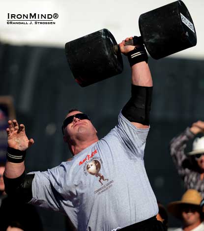 Derek Poundstone set a world record in the Giant Dumbbell Press at the 2012 World’s Strongest Man contest. Will he be able to qualify for WSM 2013 this weekend, flying on one wing? IronMind® | Randall J. Strossen photo.
Derek Poundstone set a world record in the Giant Dumbbell Press at the 2012 World’s Strongest Man contest. Will he be able to qualify for WSM 2013 this weekend, flying on one wing? IronMind® | Randall J. Strossen photo.