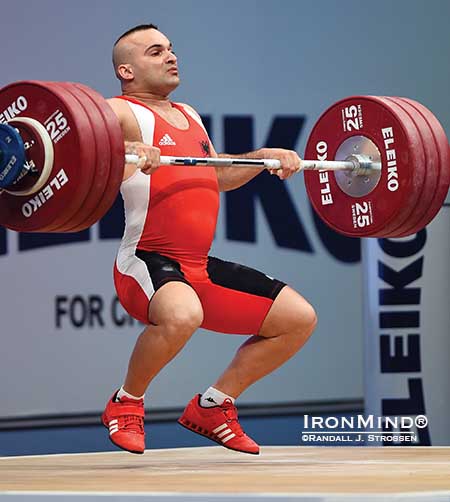Erkand Qerimaj (Albania) flies under 194 kg in the clean and jerk, adding a gold medal in the total to the one he'd already harvested in the clean and jerk in the 77-kg class at the European Weightlifting Championships in Tel Aviv.   IronMind&reg; | Randall J. Strossen photo