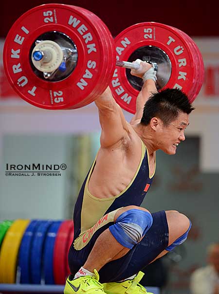77-kg weightlifter Lyu Xiaojun hits the bottom with a 176-kg world record snatch locked out overhead.  IronMind&reg; | Randall J. Strossen photo